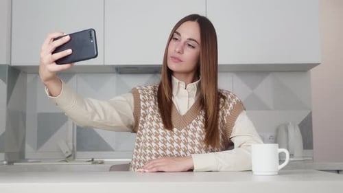 Cheerful Woman Taking a Selfie in Kitchen