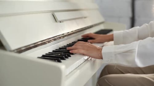 Young Adult Plays Piano at Home