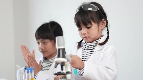 Young Girls Doing Science Experiments in a Lab