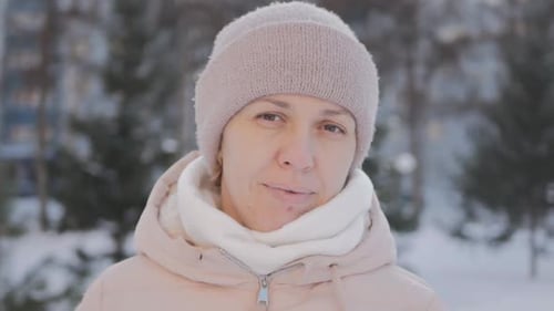 Woman in Winter Beanie Stares at Camera