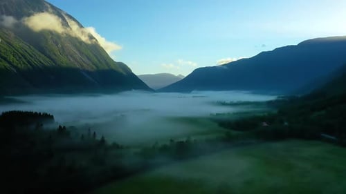 Morning Mist Over the Valley Among the Mountains in the Sunlight