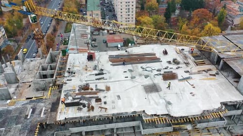 Aerial view of a new construction site. Top view on a roof of high-rise building in autumn