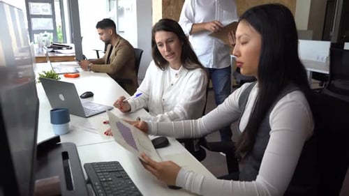 Women reading documents in office