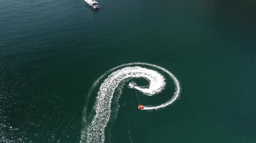 Jet Ski Pulls Inner Tube Across Open Water