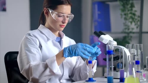 Female Scientist Working with Test Tubes in Laboratory