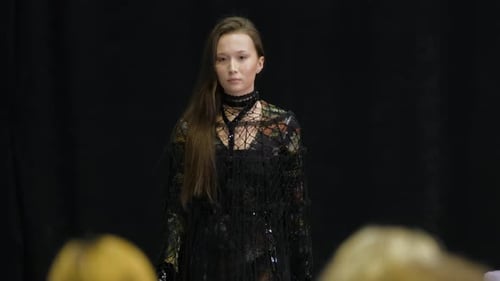 Model Walking on Fashion Runway in Dark Dress