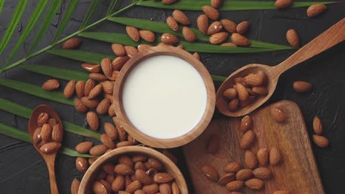 Close Up of Almonds in Wooden Bowl and Almond Milk