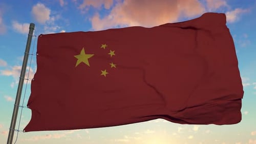 Chinese Flag Waving Against Blue Sky at Sunset