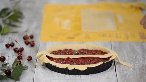 Hands Creating a Delicious Cherry Pie