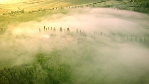Flying over the foggy Tuscany Italy landscape