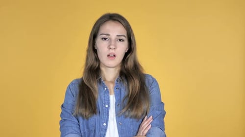 Young Woman Looking Annoyed with Arms Crossed