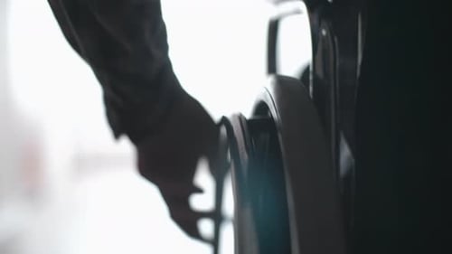 Hand Pushing Wheelchair in Dark Room