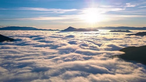 Aerial View of Golden Clouds Above Mountains