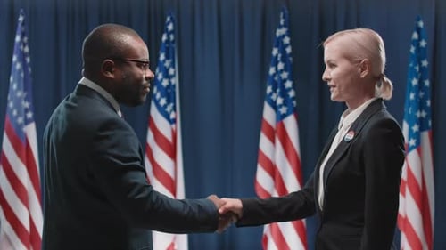 Business People Shaking Hands in Front of US Flags