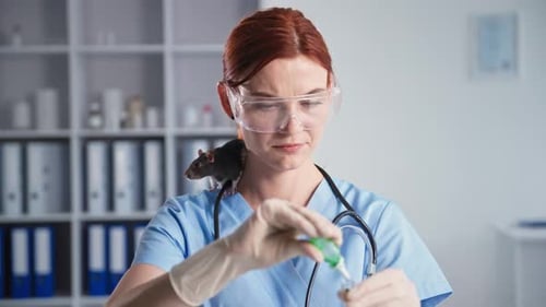 Young Woman Scientist with Rat in Laboratory
