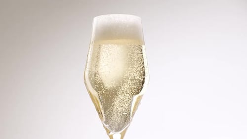 Sparkling Champagne Poured into a Glass Flute