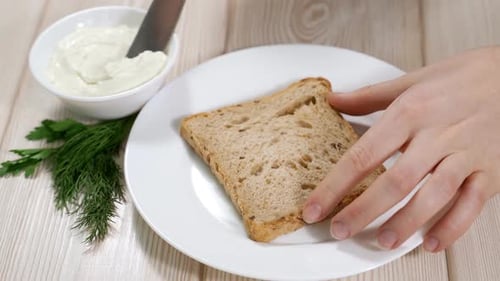 Spreading Creamy Dip on Bread Slice