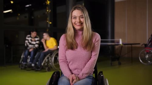 Smiling Young Woman Sitting in Wheelchair