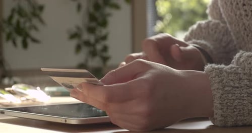 Woman Uses Tablet and Credit Card