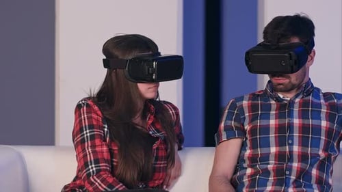 Enthusiastic Man and Woman Experience Virtual Reality Headsets