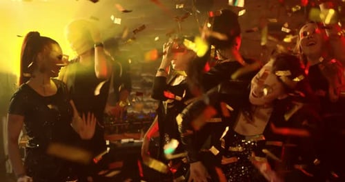 Young Adults Dancing and Celebrating at Party with Confetti