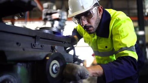 Factory Worker is Setting Up CNC Lathe Machine
