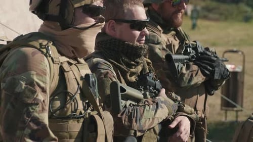 Soldiers Armed with Rifles Wearing Camouflage Gear