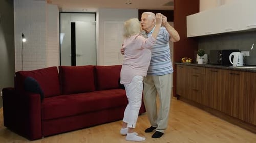 Senior Couple Dancing Together in Home Interior
