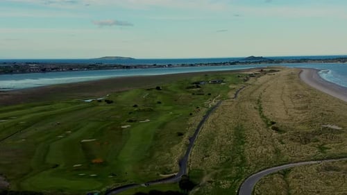 Aerial View of Scenic Coastline with Beach and Golf