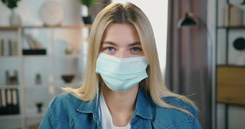 Young Woman Wearing a Surgical Mask Indoors