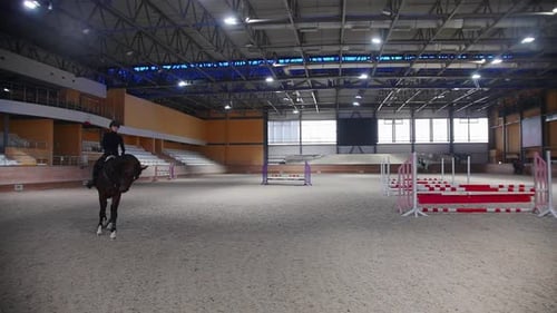Equestrian Sports a Woman in Black Clothes Walking Around the Arena on the Horseback