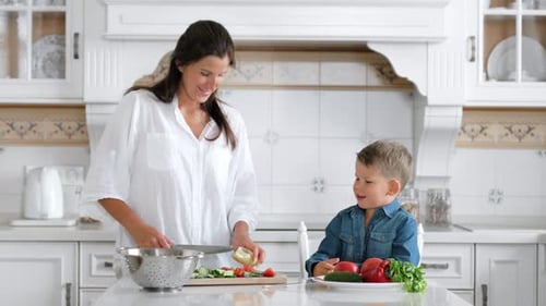 Woman and Child Preparing Fresh Vegetables Together