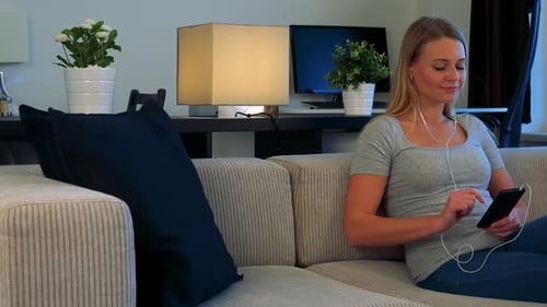 Woman Listening to Music on Couch