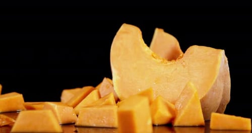 Sliced Ripe Pumpkin Falls on the Table.