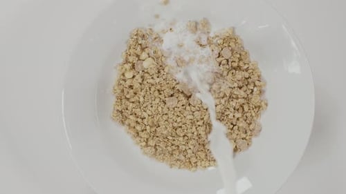 Milk Poured Over Cereal in Bowl for Breakfast