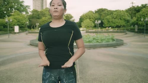 Asian woman exercise in park outdoor with new normal in COVID-19 situation