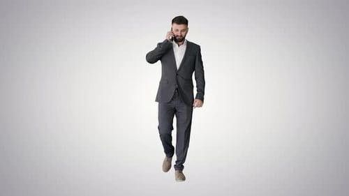 Man in Suit Talking on Phone While Walking