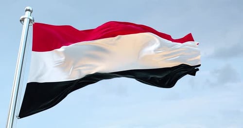 Yemen Flag Waving in the Wind against Blue Sky