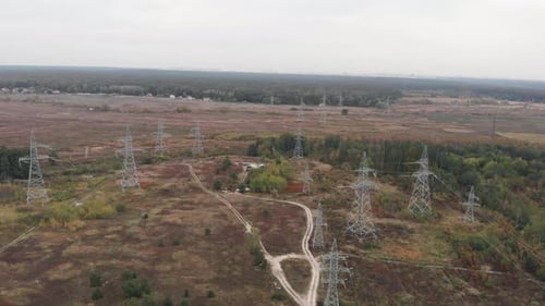 High voltage power pylons. Tower of power lines in the forest. Electric tower lines. Green energy