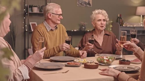 Senior Friends Toasting at Festive Dinner Party