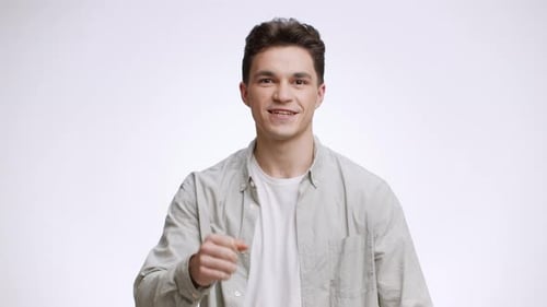 Excited Man Celebrates Achievement Against White Background