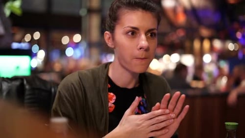 Woman Eating Food in a Restaurant at Night
