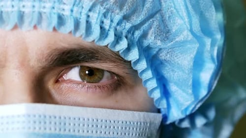 Macro Close Up of Man's Surgeon Eye, Doctor with Face Mask Ready for Operation