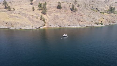 Young woman taking a bath in deep blue Okanagan Lake during a hot summer day in Canada. Fast approac