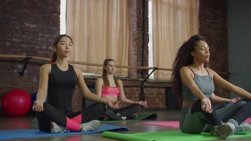 Women Meditating Together in Yoga Class