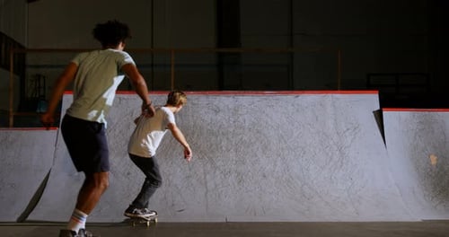 Male friends practicing skateboarding 4k