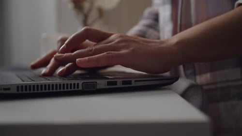 Close Up of Hands Typing on Laptop Keyboard