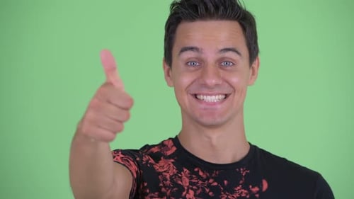 Enthusiastic Young Man Giving Thumbs Up Gesture
