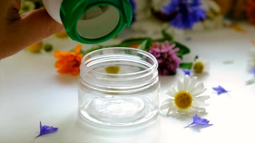 Jar Filled with White Lozenges with Flowers