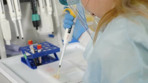 Back View of Female Scientist in Medical Uniform in Research Laboratory